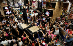 Shoppers reach for retail items on Black Friday at a store in Sao Paulo