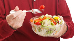 Senior Man Eats Salad — Closeup