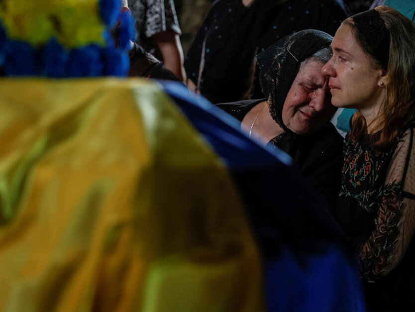 Погибшие украинцы / Фото: REUTERS - ALINA SMUTKO