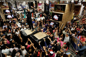Shoppers reach for retail items on Black Friday at a store in Sao Paulo