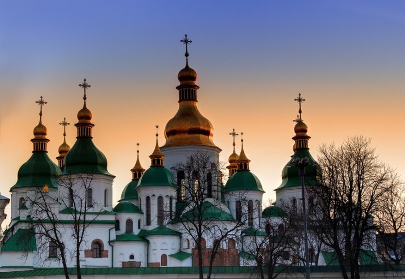 Domes of Saint Sophia Cathedral in Kiev over dramatic sunset sky