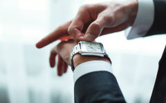Businessman adjusts clock