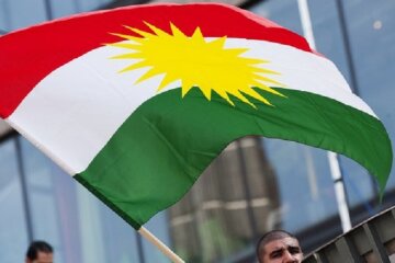 A man holds the Kurdish flag on Septembe