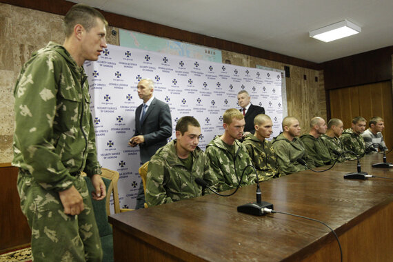 A group of Russian servicemen, who are detained by Ukrainian authorities, arrive at a news conference in Kiev