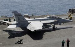 A F/A-18E/F Super Hornets of Strike Fighter Attack Squadron 211 (VFA-211) is lined up for take off on the flight deck of the USS Theodore Roosevelt (CVN-71) aircraft carrier in the Gulf