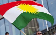 A man holds the Kurdish flag on Septembe